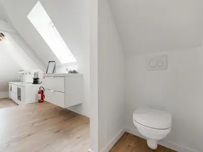 a white bathroom with a toilet and a sink at Alken Farm Stay with Terrace in Alken