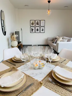 a dining room table with glasses and plates on it at Your Room with A View Bolderberg in Heusden - Zolder