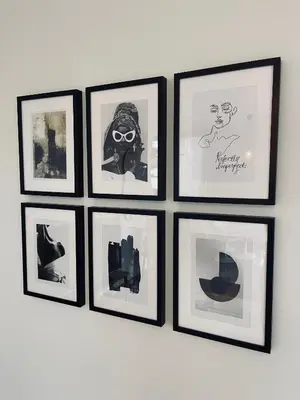 a group of framed pictures on a wall at Your Room with A View Bolderberg in Heusden - Zolder