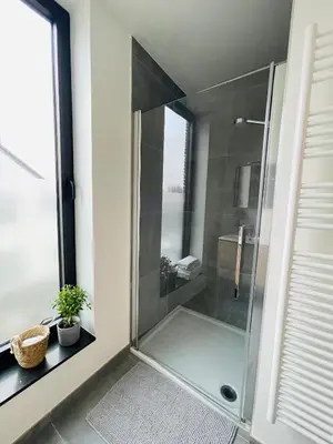 a shower with a glass door in a bathroom at Your Room with A View Bolderberg in Heusden - Zolder