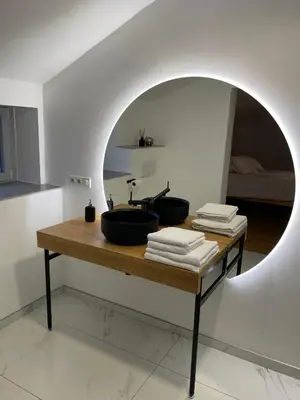 a bathroom with a sink on a table with a mirror at L'Entre-Temps in Xhendelesse