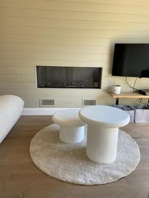 a living room with a white coffee table and a tv at Chalet Eau Vive Meinekom in Maaseik