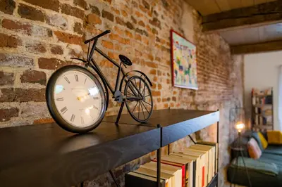a bike sitting on a table next to a brick wall at L'atelier de Liège: Tranquillité & Effervescence in Liège