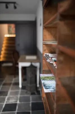 a living room with a table and a fireplace at Le Mayou in Mortroux