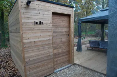 a wooden shed with a door with the word julia at Sweet Valley Julia in Zutendaal