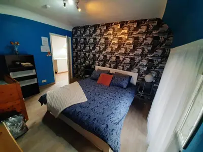 a bedroom with a bed with a wall with faces on it at Superb vacancy at Patricks house in Ketzingen