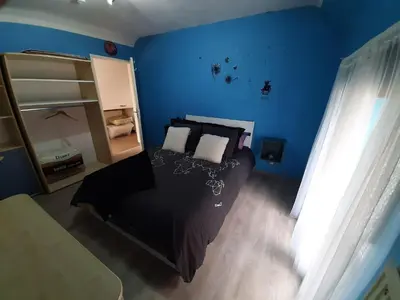 a bedroom with a black bed and a blue wall at Superb vacancy at Patricks house in Ketzingen