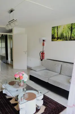 a living room with a couch and a table at Calme et verdure 9 in La Calamine