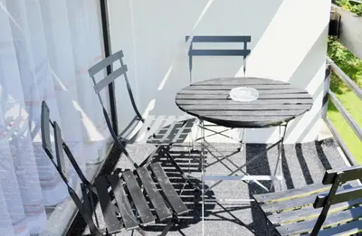 a table and chairs sitting on a balcony at Calme et verdure 9 in La Calamine