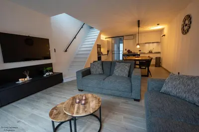 a living room with a couch and a table at Vakantiewoning Xalot in Tongeren