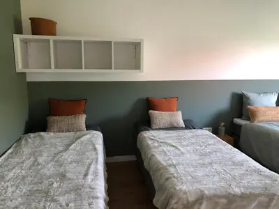 a room with two beds with pillows on them at Villa veld en velo in Bree