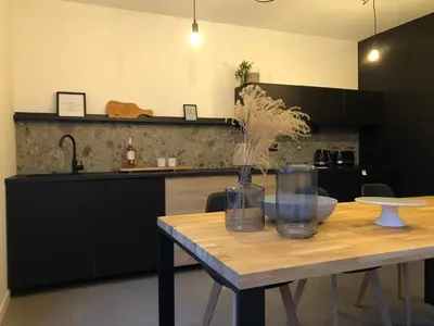 a kitchen with a table with a vase on it at Villa veld en velo in Bree
