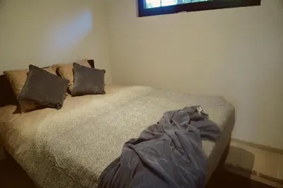 a bed with a blanket on it in a bedroom at Sweet Valley Madeleine in Zutendaal