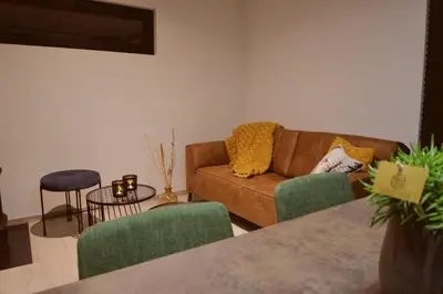 a living room with a couch and a table at Sweet Valley Madeleine in Zutendaal