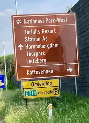 a sign for a national park next to a building at Sweet Valley Madeleine in Zutendaal