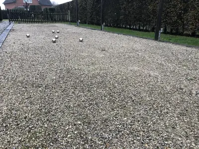 a bunch of balls sitting on top of a gravel field at 14P 5B Villa de Poothoeve with Sauna and beautiful garden in Bilzen