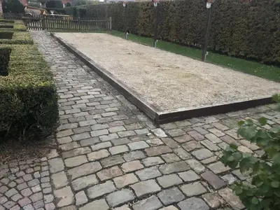 a stone walkway in a yard with a fence at 14P 5B Villa de Poothoeve with Sauna and beautiful garden in Bilzen