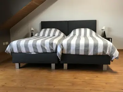 two beds sitting next to each other in a bedroom at 8P 3B Cozy vacation home for 8 persons in Heers in Heers