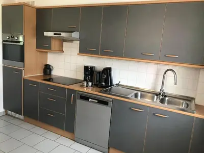 a kitchen with gray cabinets and a sink at 8P 3B Cozy vacation home for 8 persons in Heers in Heers