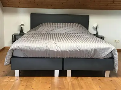 a bedroom with a large bed with two lamps on tables at 8P 3B Cozy vacation home for 8 persons in Heers in Heers