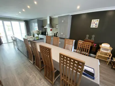 a kitchen with a large island with chairs and a counter at 8P 3B Cosy vacation home for 8 persons in Heers