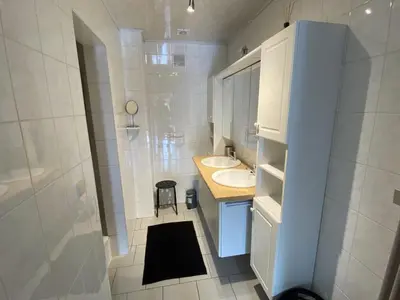 a white bathroom with a sink and a shower at 8P 3B Cosy vacation home for 8 persons in Heers