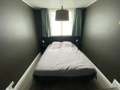 a small bed in a room with a window at 8P 3B Cosy vacation home for 8 persons in Heers