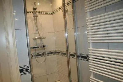 a shower with a glass door in a bathroom at Vakantiehuis Martien in Peer