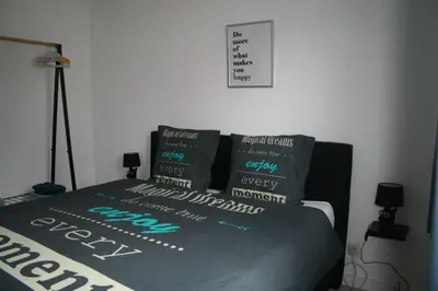 a bedroom with a bed with pillows on it at Vakantiehuis Martien in Peer