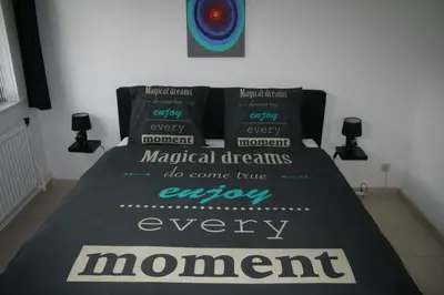 a bed with a bedspread that says magical dreams do come true every moment at Vakantiehuis Martien in Peer