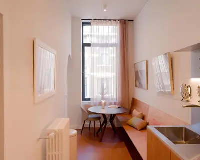a small kitchen with a table and a window at La Maison de Chestret in Liège
