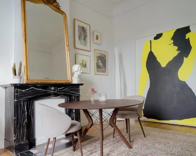 a dining room with a table and a mirror at La Maison de Chestret in Liège