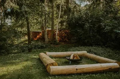 a log fire pit with a bowl in the grass at Kipdorp39 in Bree