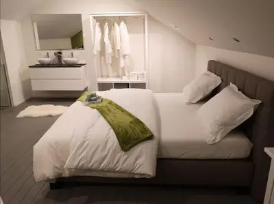 a bedroom with a white bed and a sink at Ô'bel Écrin in Aubel