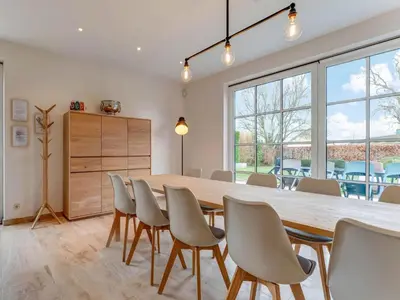 a dining room with a large wooden table and chairs at Heers Retreat with Sauna in Heers