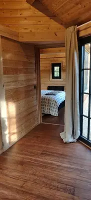 a bedroom in a log cabin with a bed in it at Chalet Duras in Sint-Truiden