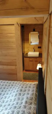 a bedroom with a sink and a bed in a cabin at Chalet Duras in Sint-Truiden