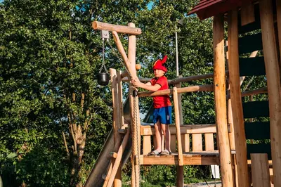 a young boy is on a playground at Glamping - 25 min Roermond, Maasmechelen & Maastricht in Kinrooi
