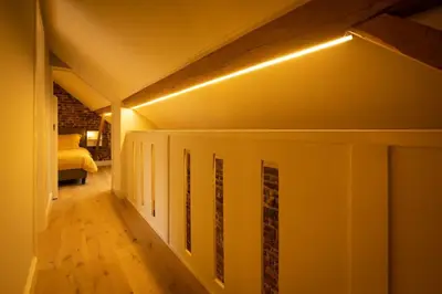 a hallway with a room with a bed and lights at Haspenhoeve Vakantiewoning in Herstappe