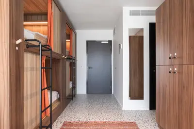 a room with bunk beds and a hallway with a door at YUST Liege in Liège