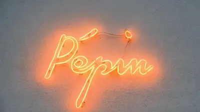a neon sign that says rrm on a wall at YUST Liege in Liège