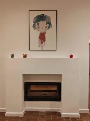 a fireplace with a painting on the wall at Hoeve Luitenant Halleux in Linter