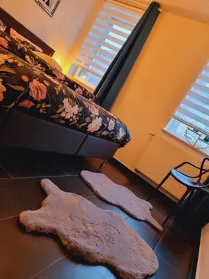 a room with two mopeds on the floor next to a bed at La suite de lati in Liège