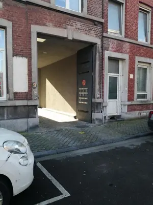 a car parked in front of a building with a garage at La suite de lati in Liège