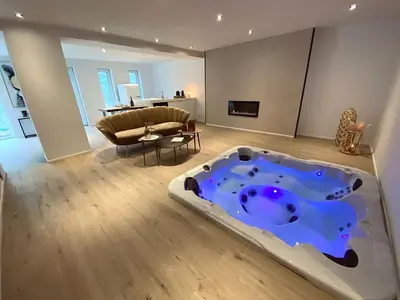 a living room with a jacuzzi tub in the middle of the room at Casa Honey in Liège