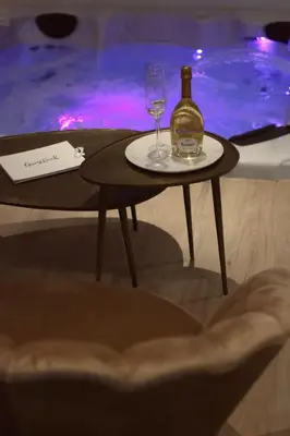 a bottle of wine and a glass on a table at Casa Honey in Liège