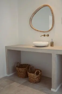 a bathroom with a sink and a mirror and baskets at Casa Honey in Liège