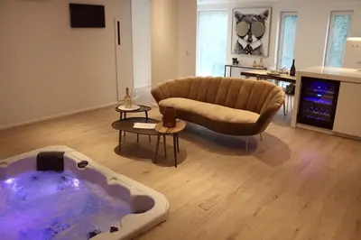 a living room with a couch and a bath tub at Casa Honey in Liège