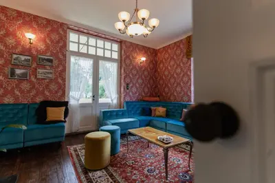 a living room with a blue couch and a table at Villa les Bruyères in Dilsen-Stokkem