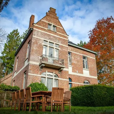 a group of chairs sitting in front of a building at Villa Asch in As